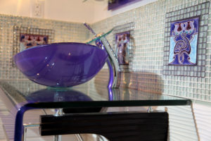 Glass and tile bathroom with custom deco tile