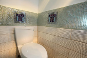 Glass and tile bathroom with custom deco tile